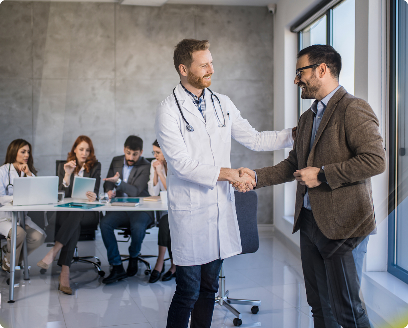 Doctor and businessman shaking hands