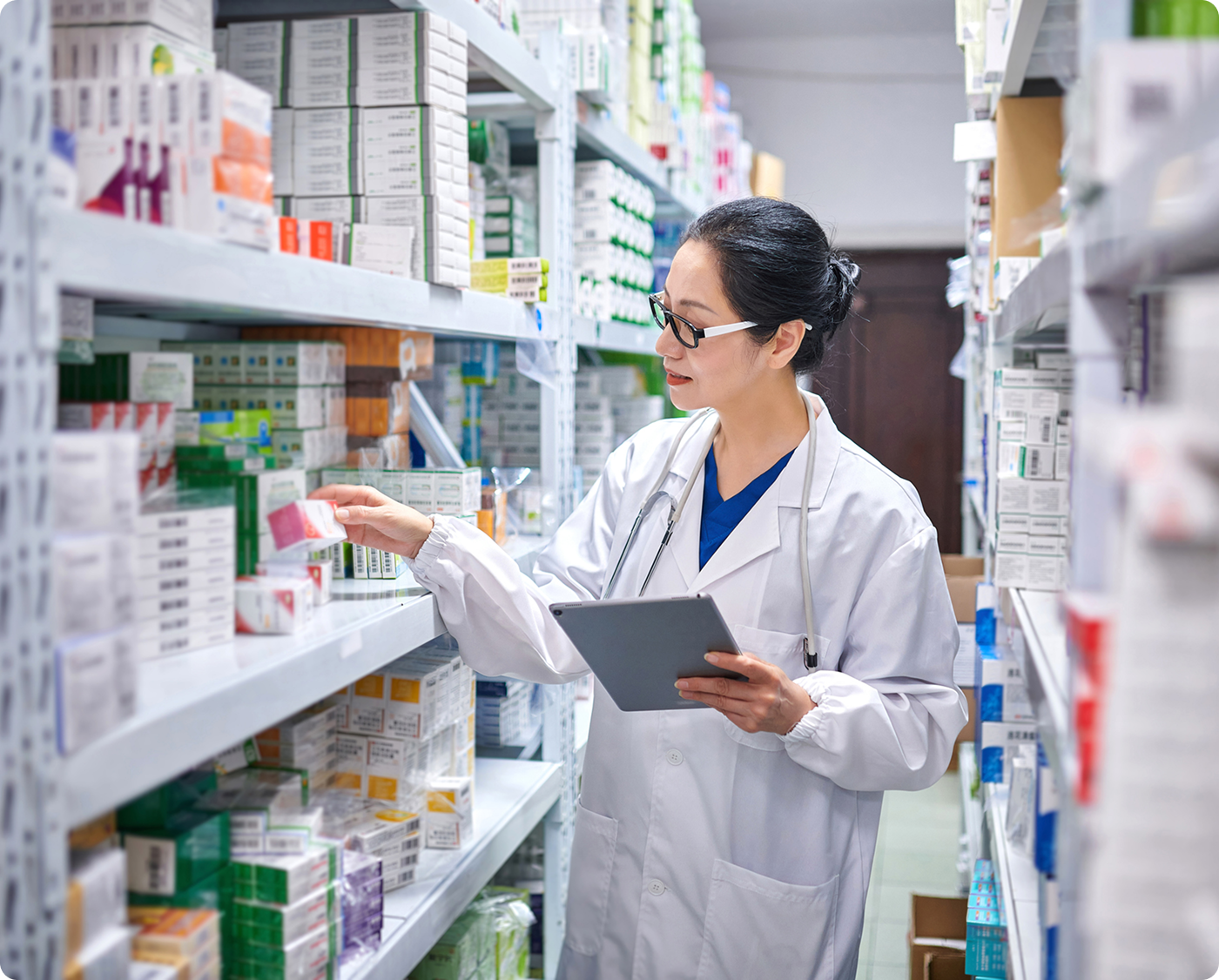 Pharmacist organizing medication on shelves